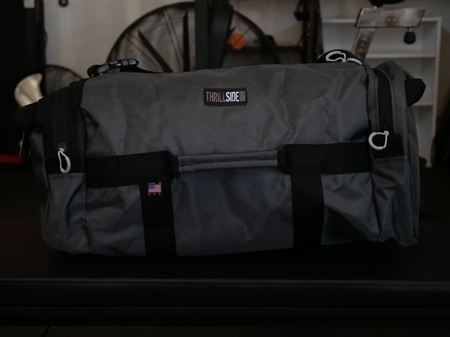 Gunmetal Gray Burner Bag Duffel with a garage gym background