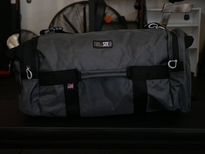 Gunmetal Gray Burner Bag Duffel with a garage gym background